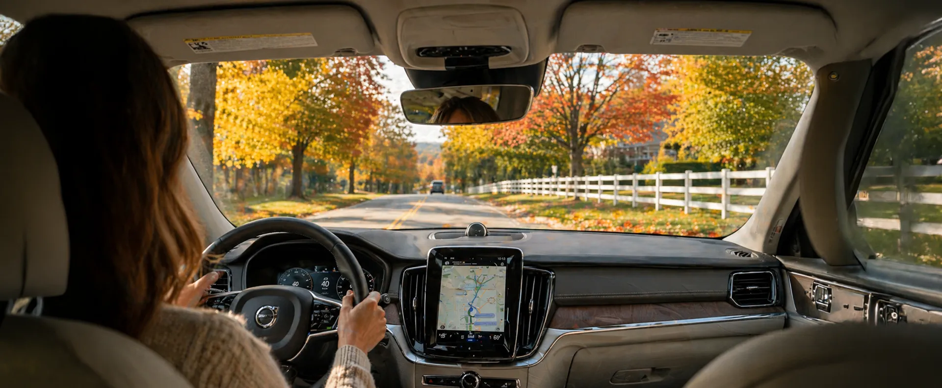 Scenic autumn roadway viewed from car windshield perspective peacefully ahead