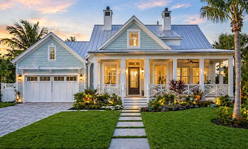 Coastal cottage exterior with landscaped garden glowing beautifully evening outdoors